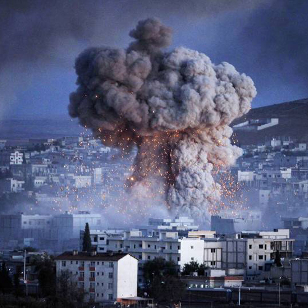 An explosion rocks Syrian city of Kobani during a reported suicide car bomb attack by the militants of Islamic State