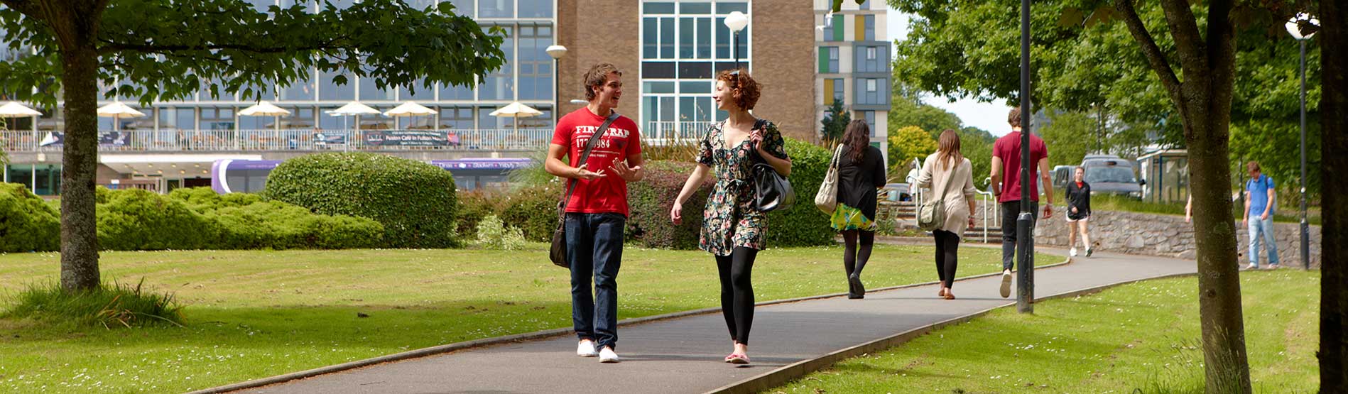 a few students walking through the grounds of the singleton park campus
