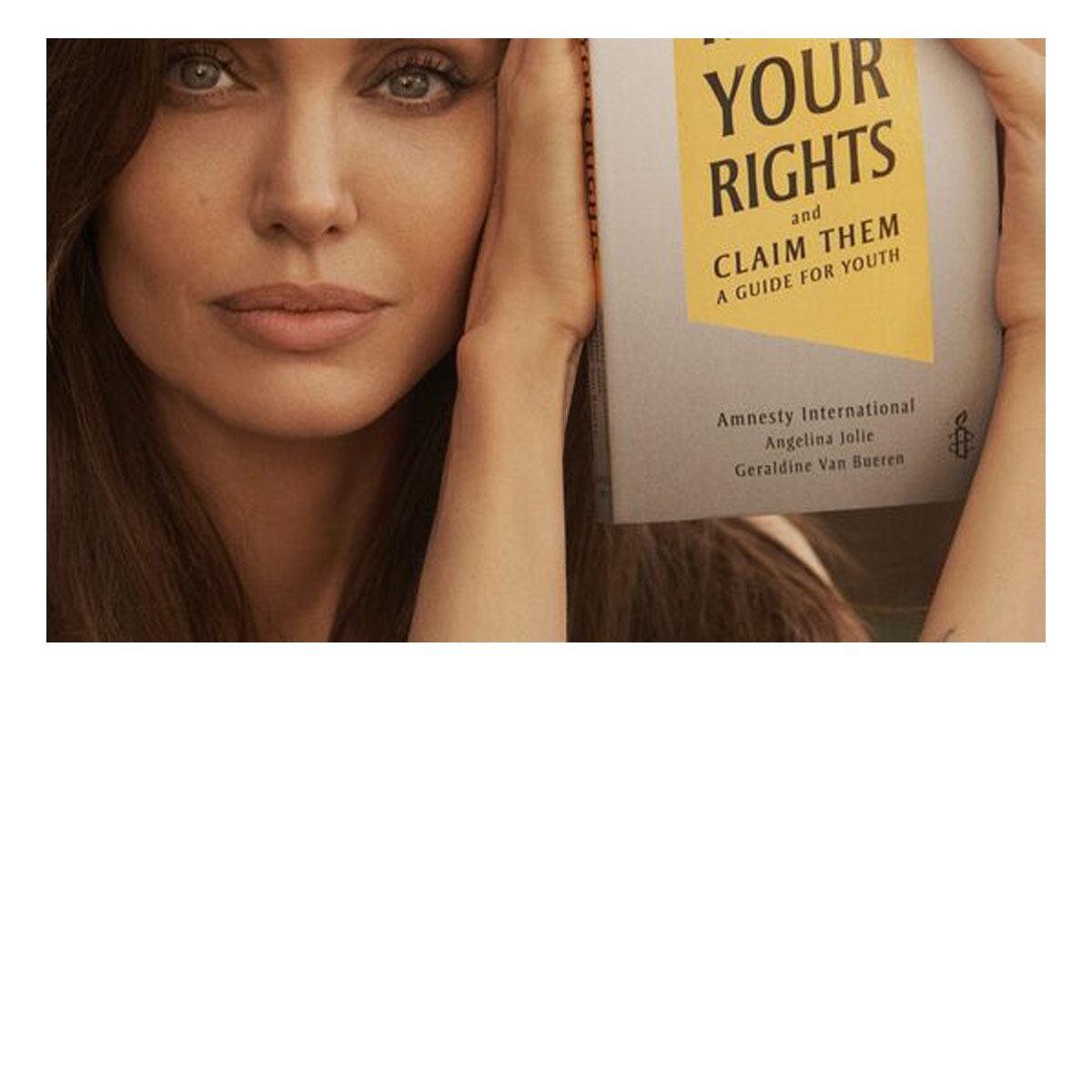 Angelina Jolie holding the Amnesty International book