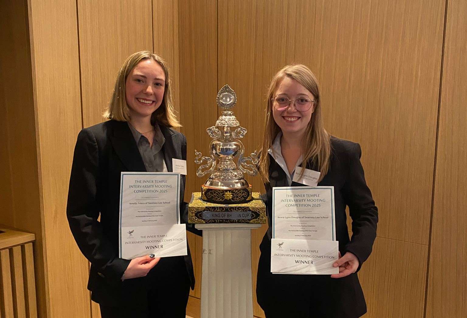 Two students with trophy in the middle