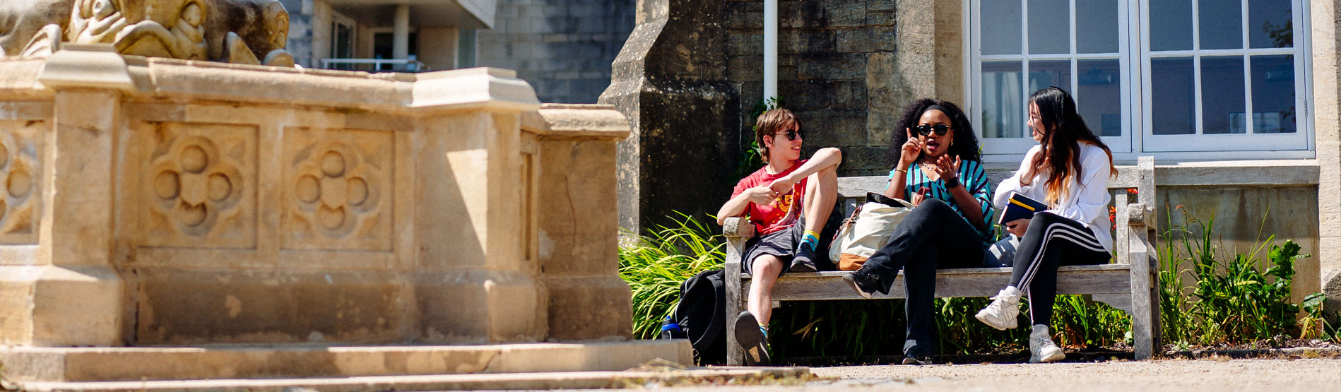 Students sitting on a bench outside Singleton Abbey