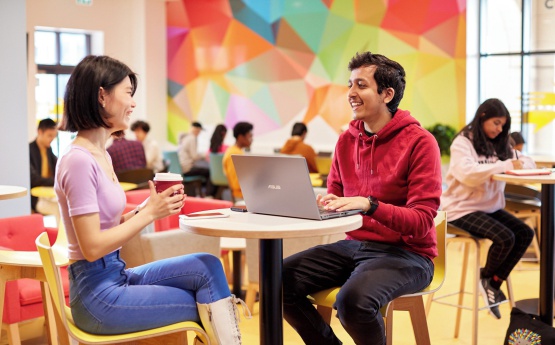 Two students sitting in the hideaway on Bay Campus