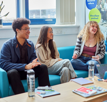 An image of three students socialising on campus. 