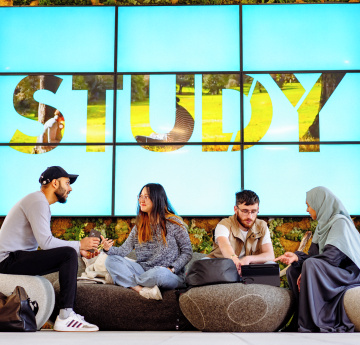 An image of a group of students talking to each other. 