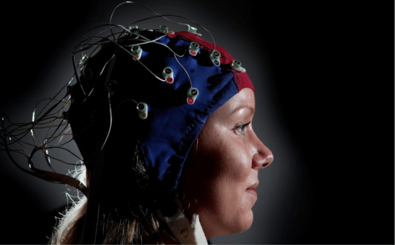 Person wearing scull cap with electrodes. 