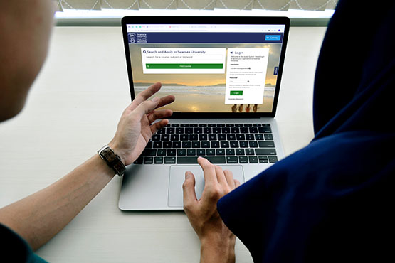 person pointing at website