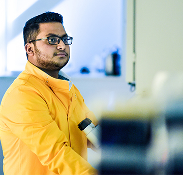 Student in Yellow Lab Coat in Lab 