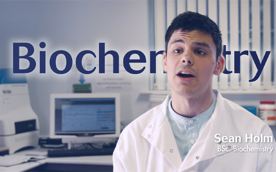 Biochemistry Student Sean Holm course video holding card. 