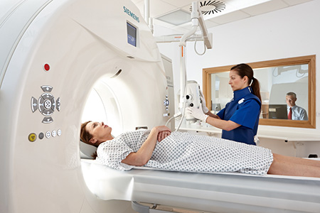 Member of staff facilitating an MRI 