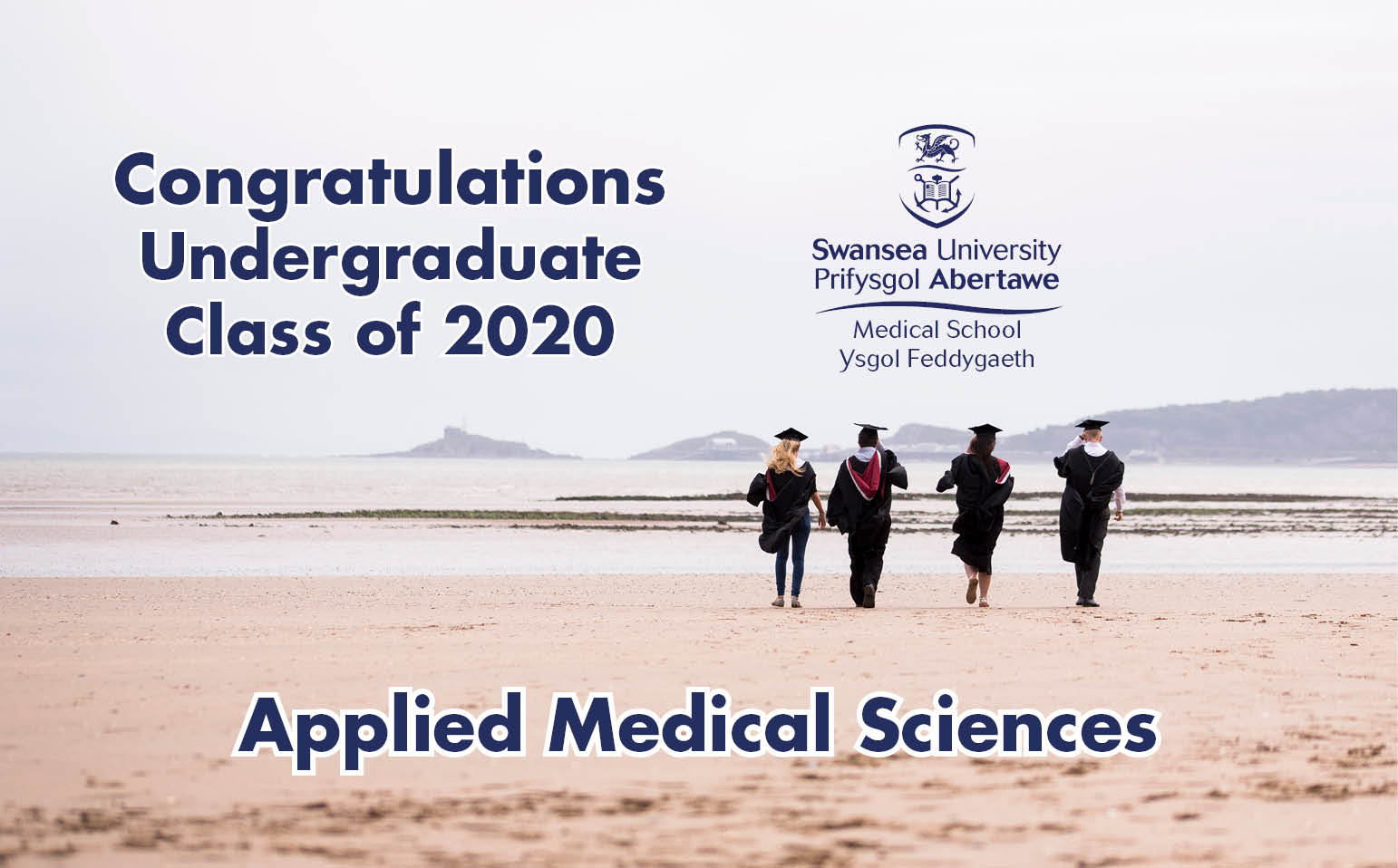Graduates wearing caps and gowns walking across Swansea Bay