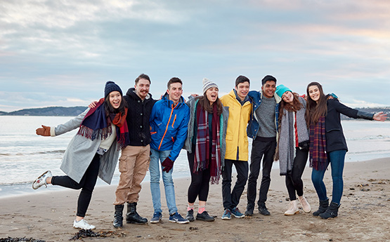 Students posing for a photo on the beach
