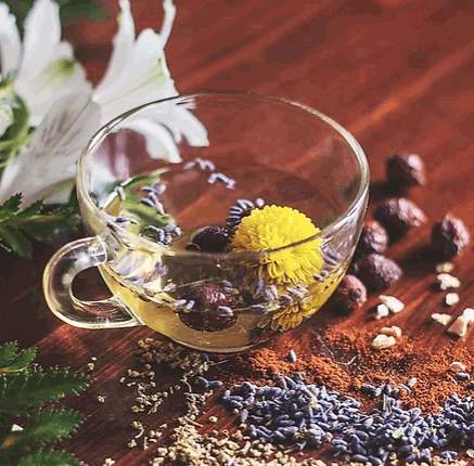 glass tea cup with natural seeds and flowers on table to depict the products key ingredients