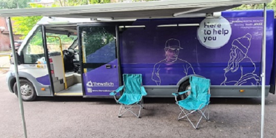 The Wallich purple bus with 2 blue chairs