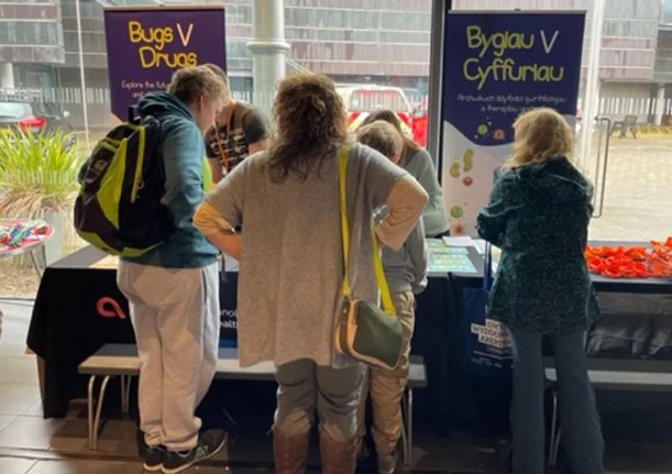 people visiting bugs v drugs stand at science festival