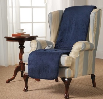 Blue seat warmer positioned on a cream armchair