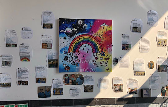 white wall containing thank you messages, patient feedback, photos of medical staff, Diolch, Thank You rainbow graphic