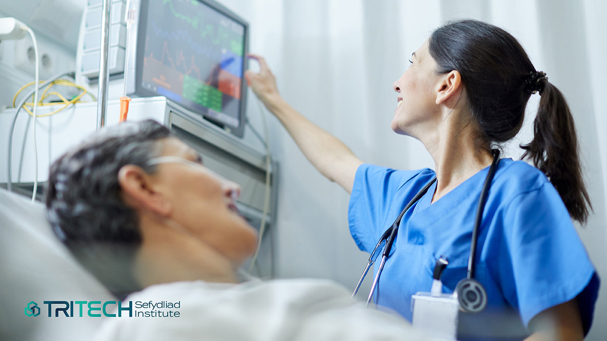 image of a clinician checking a patients information on a monitor display screen