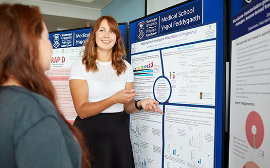 Researcher giving poster presentation