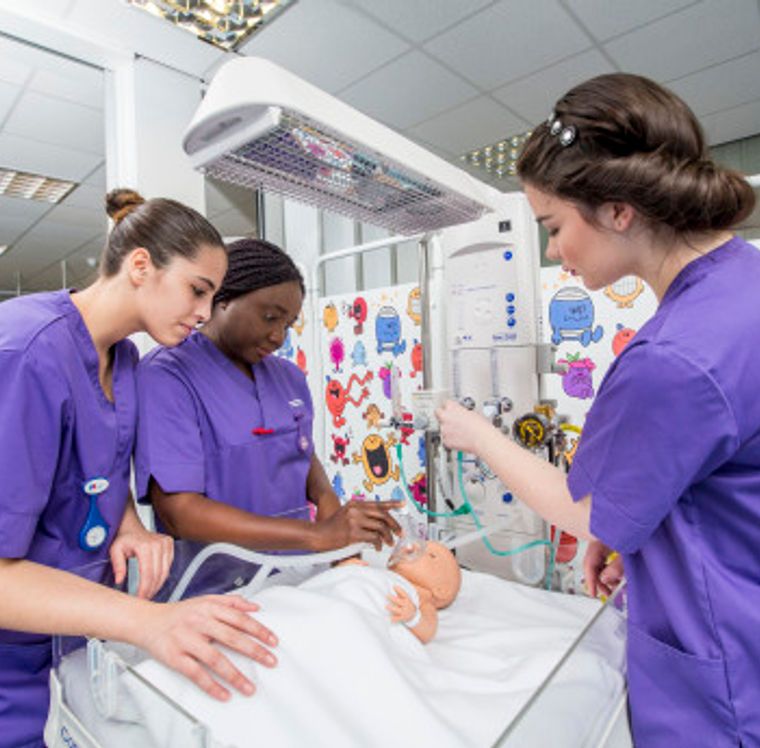 Child nursing students with a baby mannequin