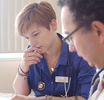 Doctor and medical student reviewing patient notes