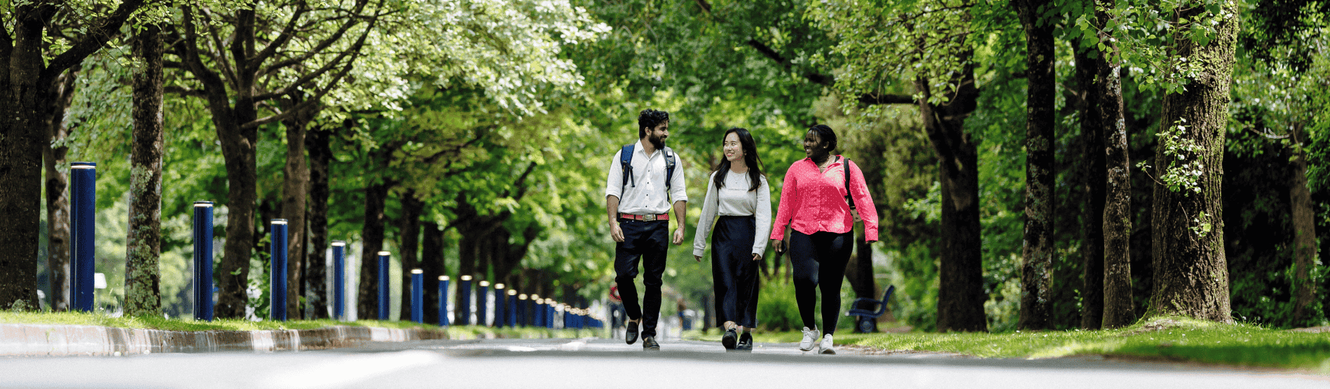 Two students discussing in a garden. 