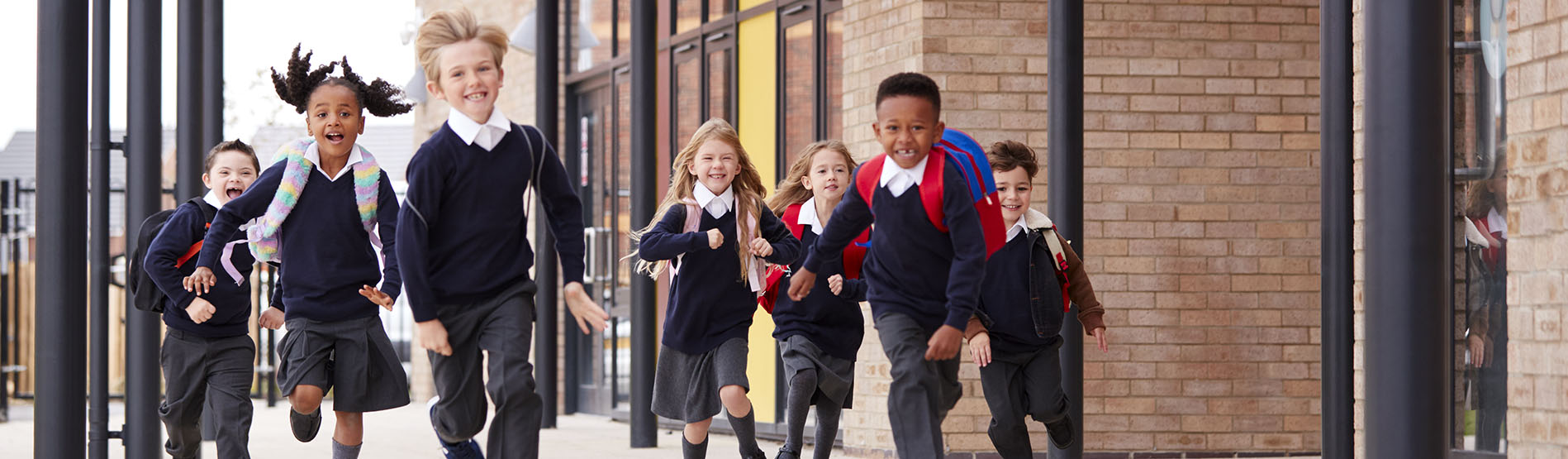 Primary school children running outside school