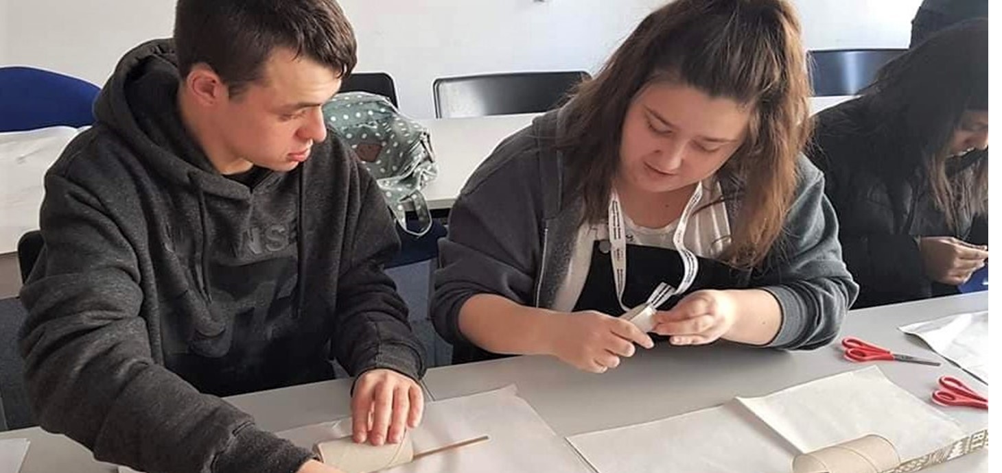 Dan and Lizzie working together wrapping presents as part of the Discovery project - pictured before the Covid-19 outbreak.. Student volunteers are continuing to support and work with disabled adults by phone during the coronavirus outbreak