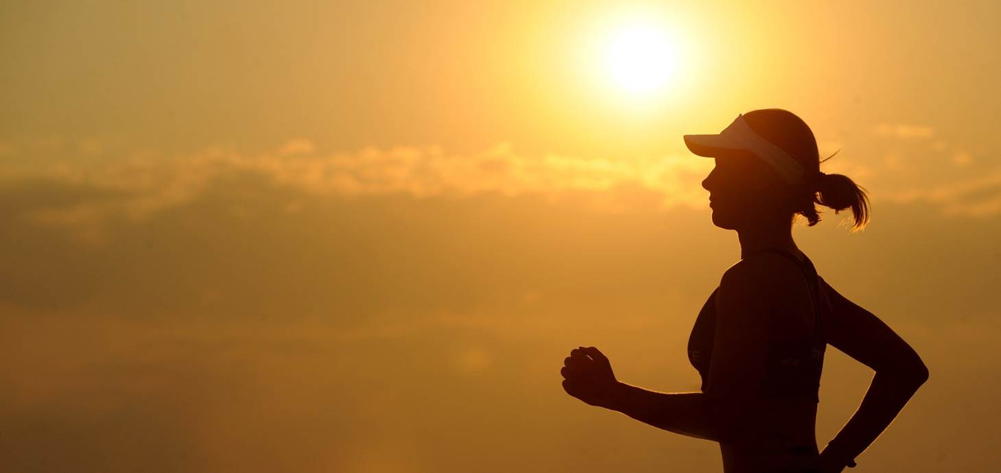 A woman running at sunset