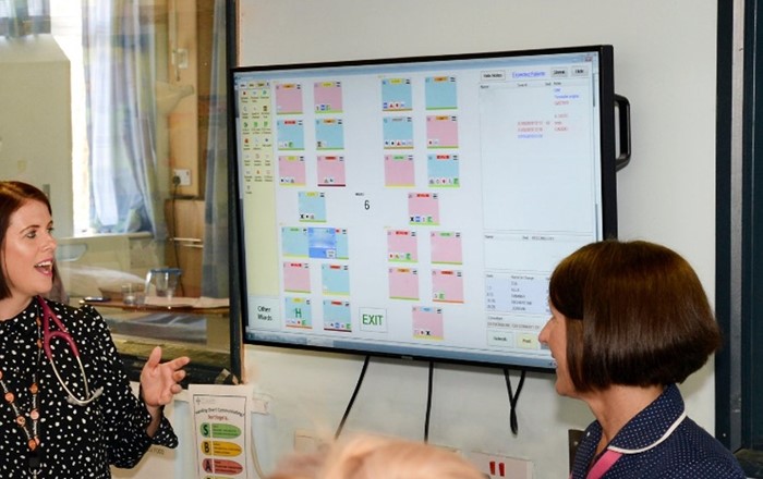 Staff explaining how the e-whiteboards would work in a hospital