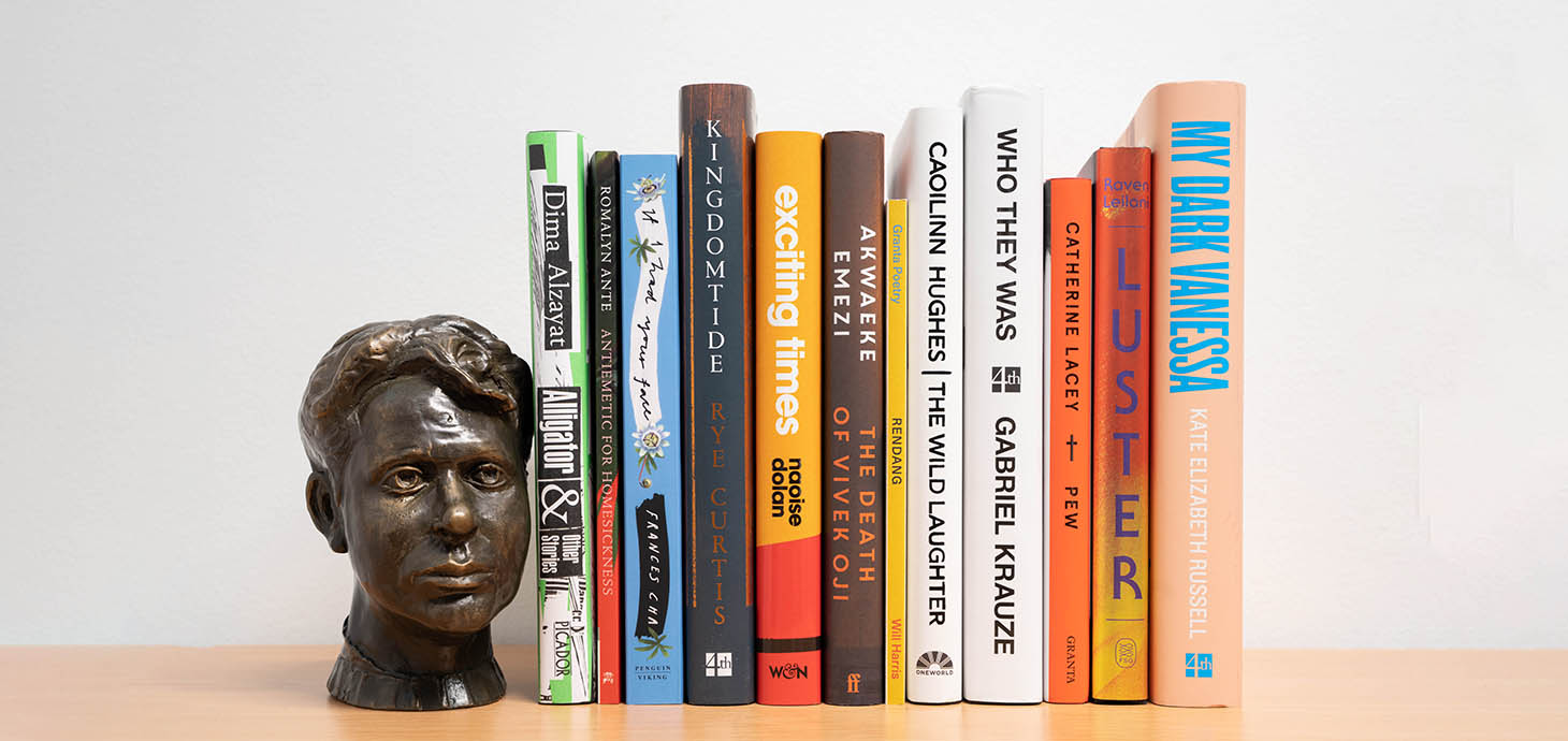 The books featured on the longlist stacked up on a shelf