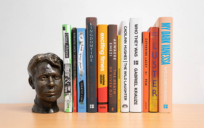 The books featured on the longlist stacked up on a shelf