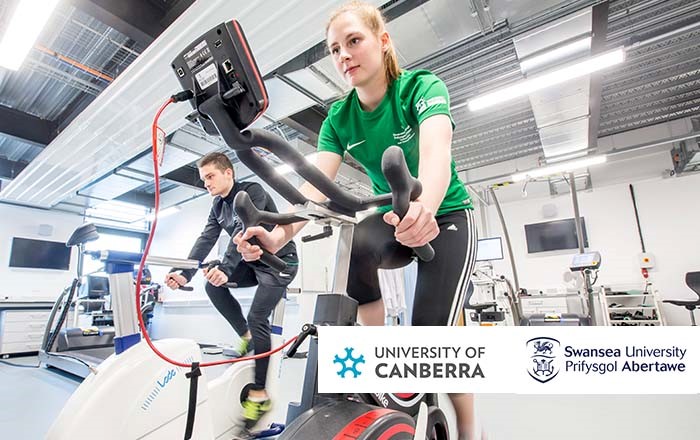 Two people on exercise bikes in a sports science laboratory:  sport and exercise science experts from Swansea and the University of Canberra (UC) in Australia have launched an official partnership which will see them collaborate on research, teaching and student exchanges.
