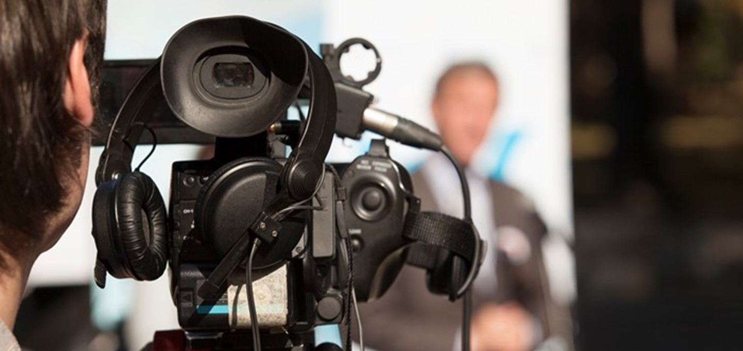 A video camera in use during a television broadcast.
