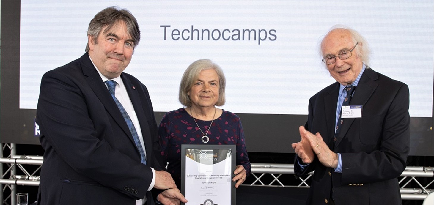 Professor Faron Moller, Director of Technocamps (left), and Beti Williams (centre), Patron, receive the award from Nobel laureate Professor Sir Martin Evans