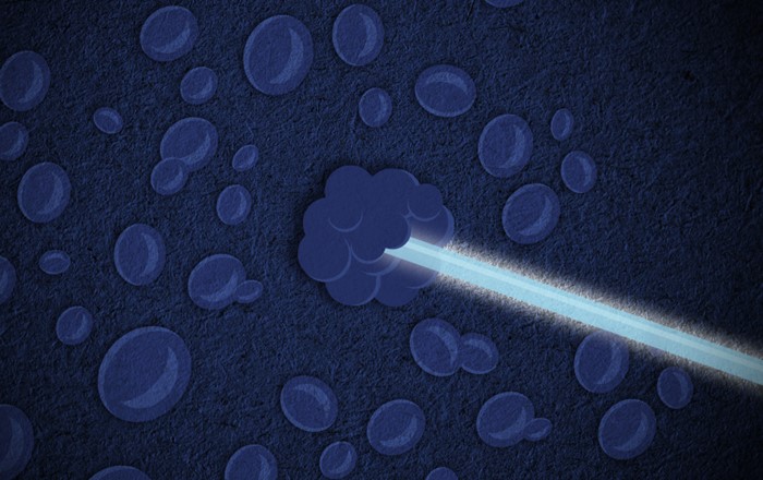 Illustration of blue beam of light, which represents a proton beam targeting a blue cell, which represent a cancer cell. 