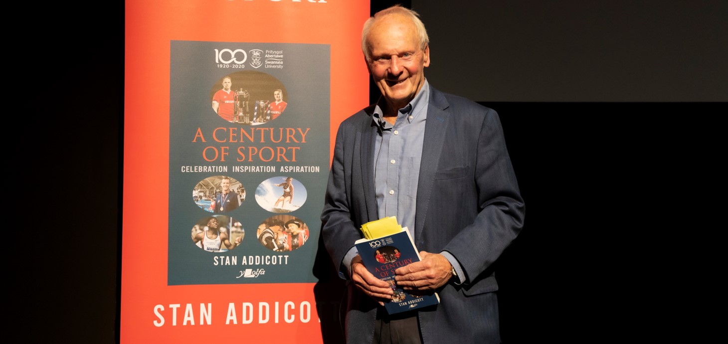 Stan Addicott holding a copy of A Century of Sport