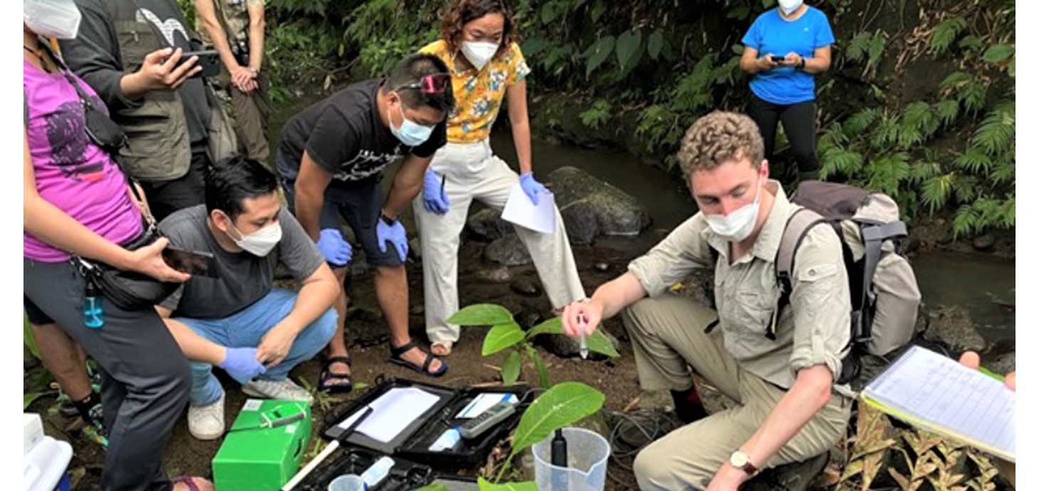 Aaron Todd (right) with Filipino colleagues. He conducted fieldwork with a team of eight researchers across two river catchments, collecting water and sediment samples
