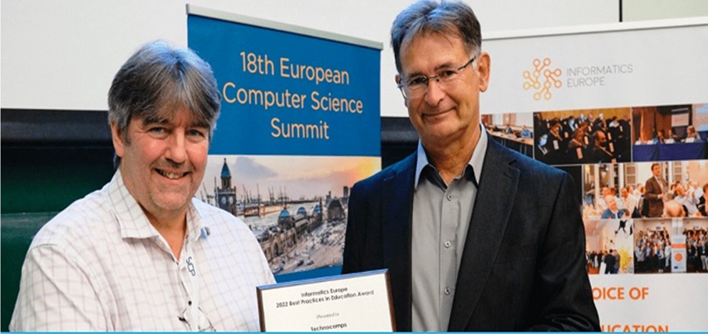 Professor Faron Moller, left, director of Technocamps, receives the award for best practice in education