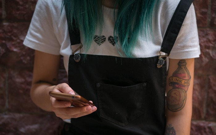 Close-up of young woman using smart phone