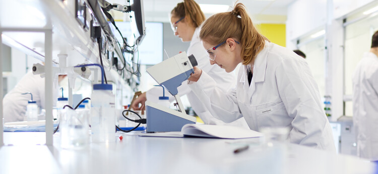Female students working in a chemistry lab