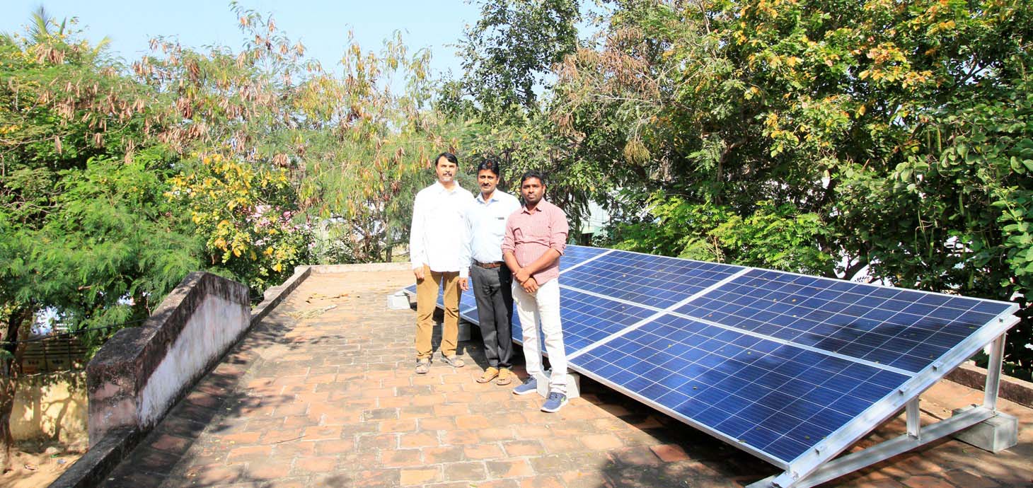 Researchers from Professor Satish Patil’s group at IISc Bangalore standing next to a solar-powered micro-grid they installed at a school in Tamilnadu, India, as part of Swansea University’s SUNRISE project.