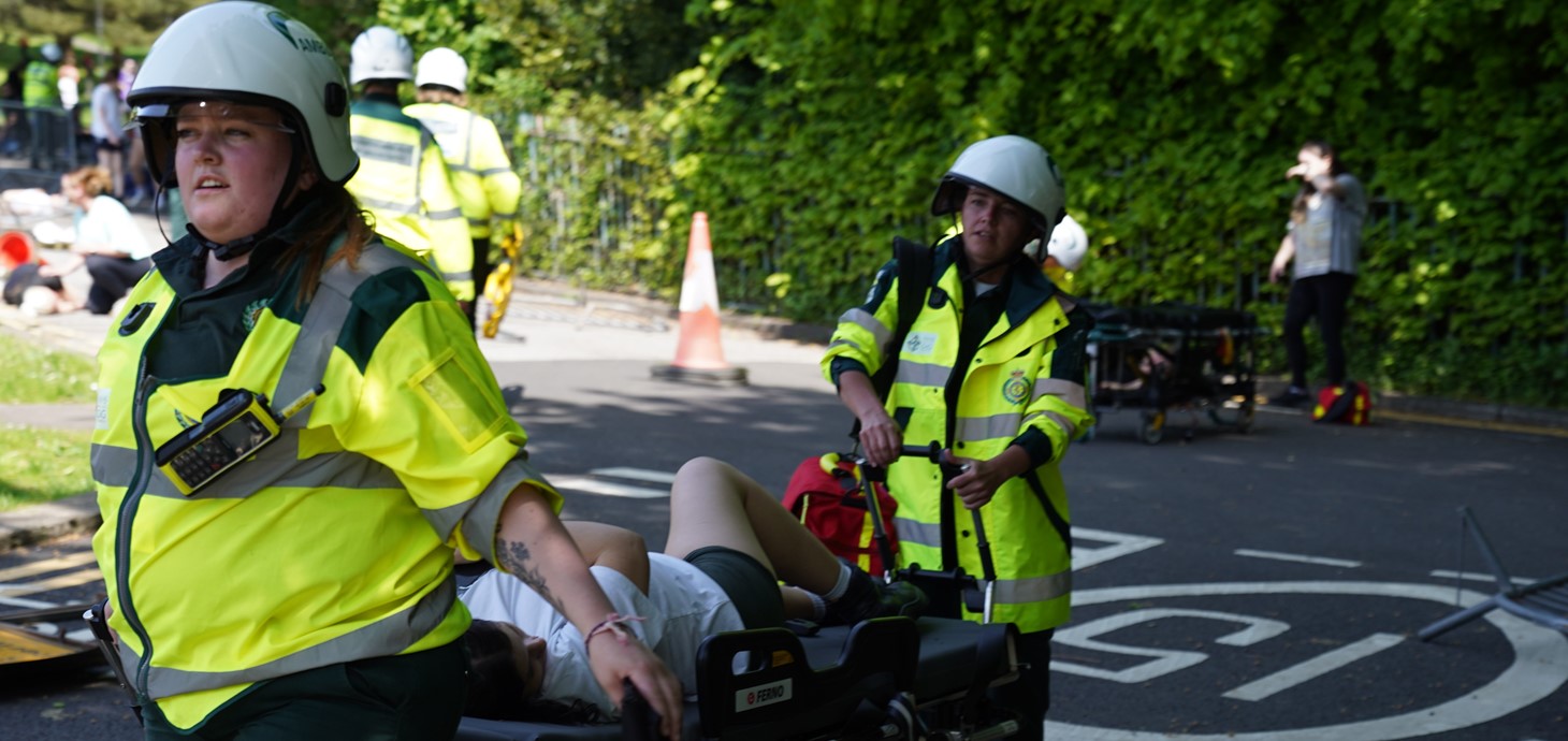 Third-year paramedic students attending to a patient on a stretcher during the exercise.