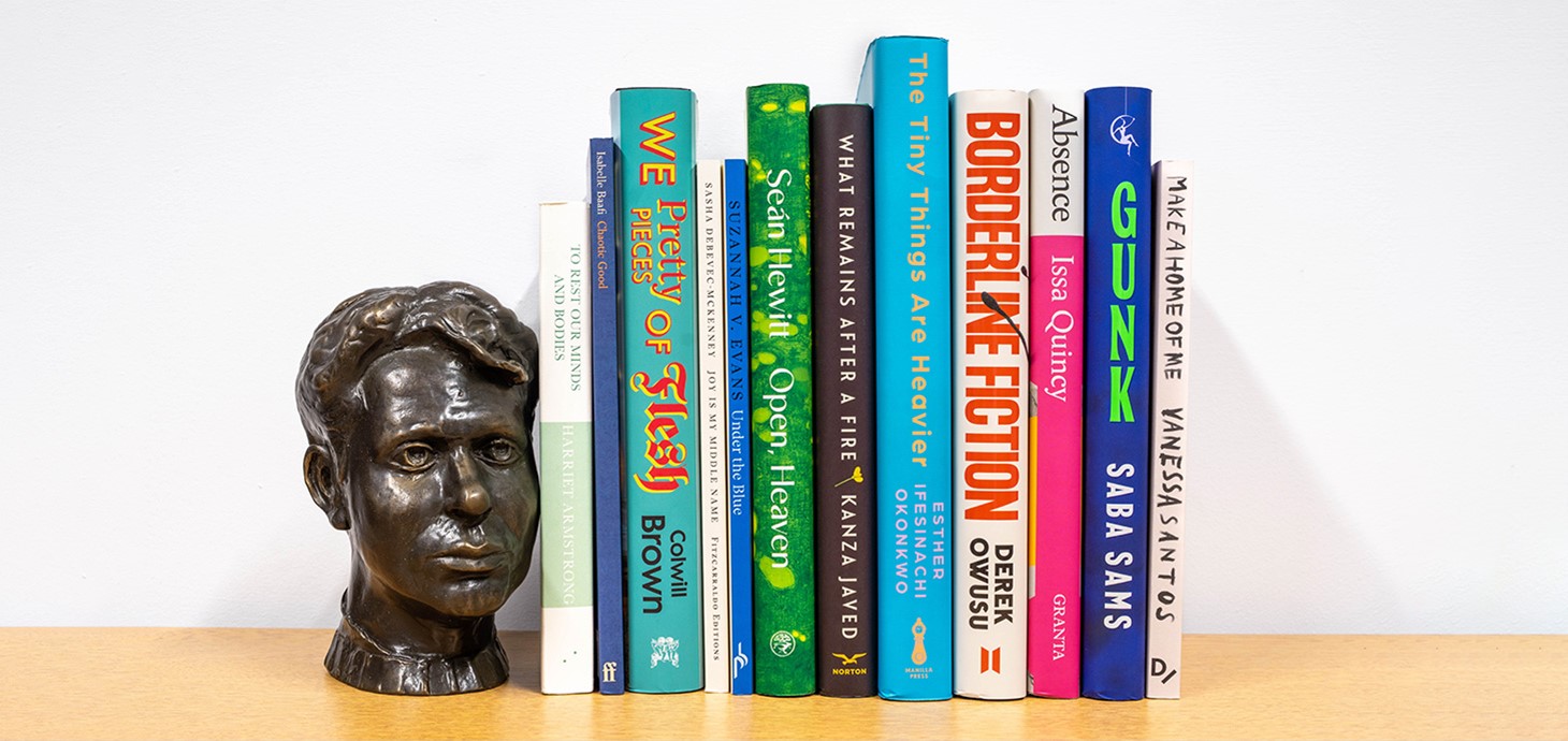 The books featured on the longlist on a shelf next to a small bust of Dylan Thomas