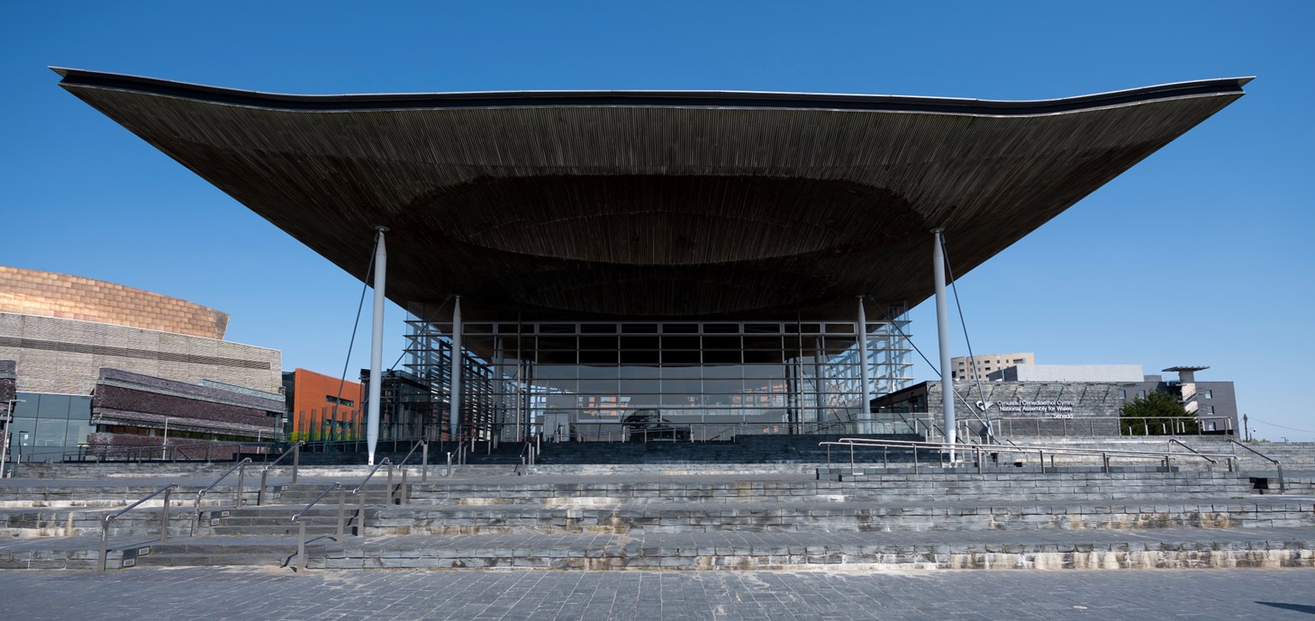The Senedd building pictured against a blue sky 