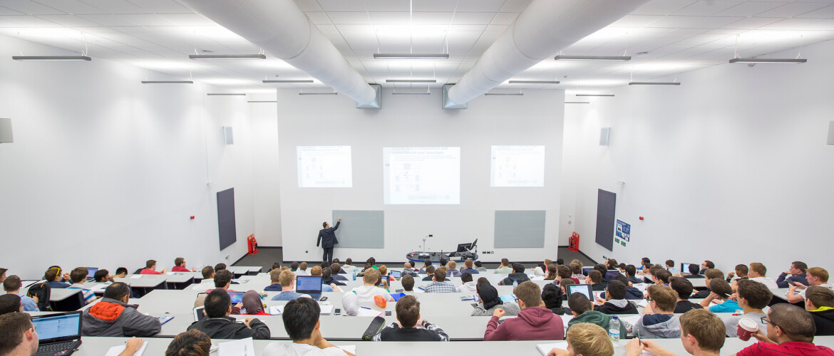 A lecturer teaching students in a lecture theatre 