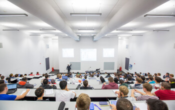 A lecturer teaching students in a lecture theatre 