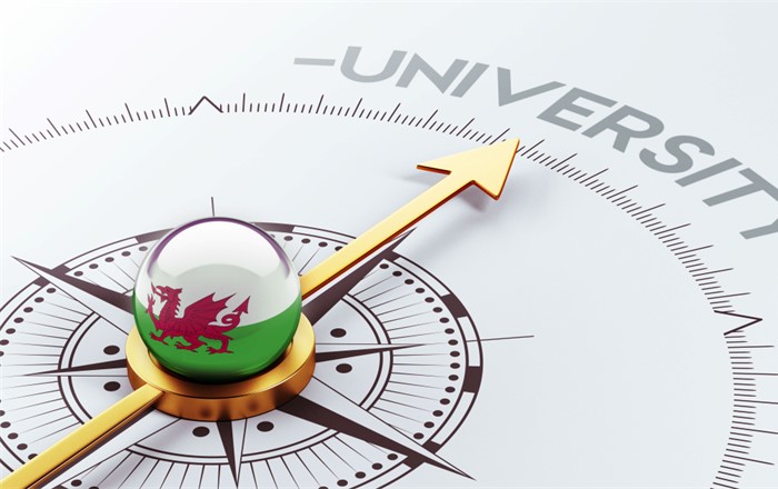 A compass is shown with the compass rose depicted as a Welsh flag with the magnetic needle pointing to 'University' as the destination.
