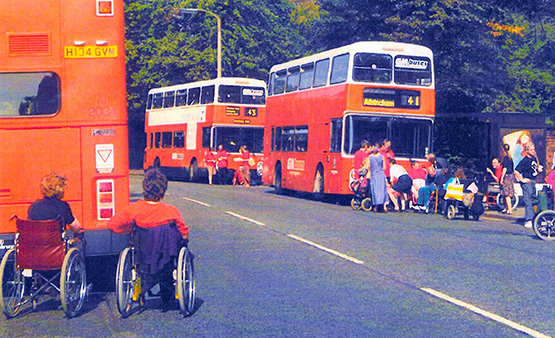 Image of people in wheelchairs waiting for bus