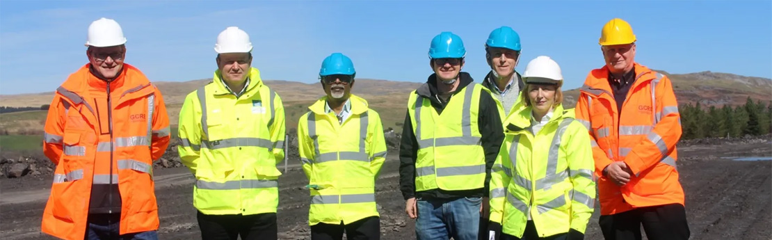 Senior representatives from the Global Centre of Rail Excellence and Swansea University at the site which is currently under construction in Onllwyn.