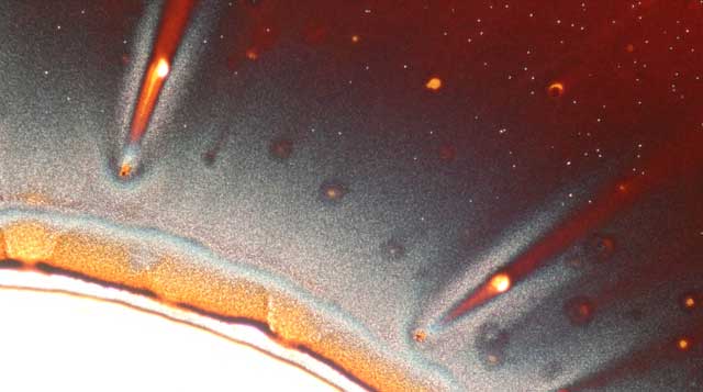 Image from under a microscope, with orange and red lines
